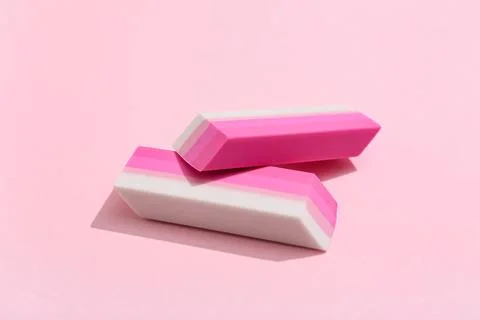 Rubber erasers on pink background 库存照片
