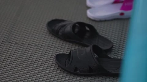 Rubber flip flops in the pool Stock Footage 310268538