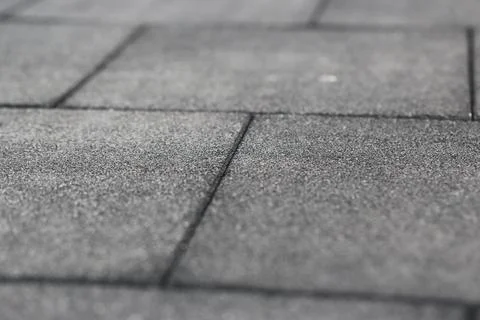 Rubber flooring is shown in a close-up view. This flooring is often used in.. Stock Photos