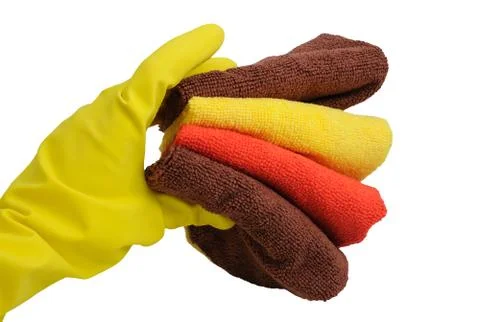 Rubber glove and stack of towels Stock Photos