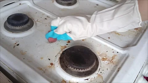 Rubber-gloved hands sponge the gas stove Video stock 311697222