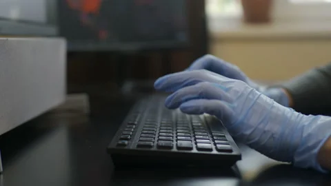 Rubber-gloved hands typing on eng-rus keyboard, prevent virus spreading Stock Footage 149565796