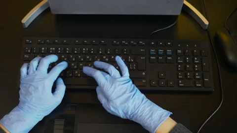 Rubber-gloved hands typing on eng-rus keyboard, prevent virus spreading Stock Footage 149923570