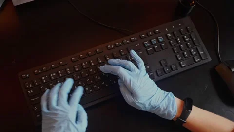 Rubber-gloved hands typing on eng-rus keyboard, prevent virus spreading Stock Footage 152215519