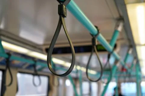Rubber handle loops on light blue tube, for passengers to hold safely duri... Photos