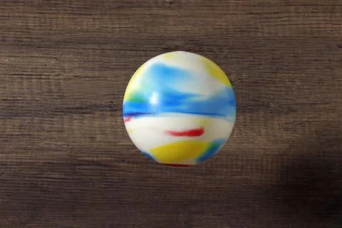 Rubber multicolor ball on a dark background. Stock Photos