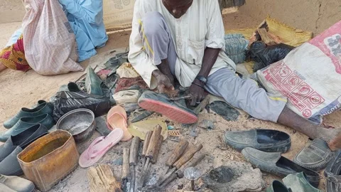 Rubber Shoe Repair Using Fire At Local Market Kano Nigeria Stock Footage 323366934