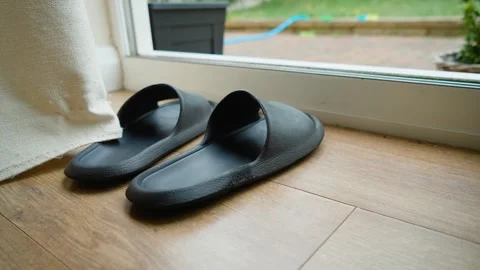 Rubber slide sandals placed beside open sliding door in residential home. Indoor 스톡 동영상 337418339