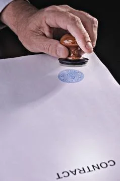 Rubber stamp in a hand Stock Photos
