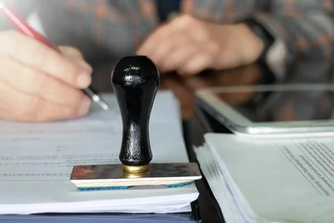 Rubber stamper on white paperwork Stock Photos