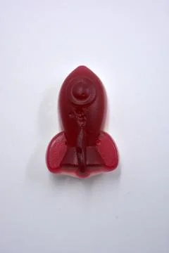 Rubber sweets in the form of red, cherry space rockets. Stock Photos