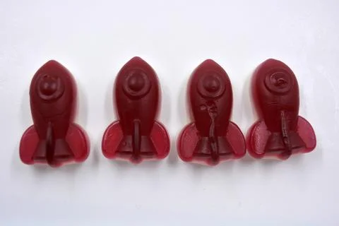 Rubber sweets in the form of red, cherry space rockets. Foto stock