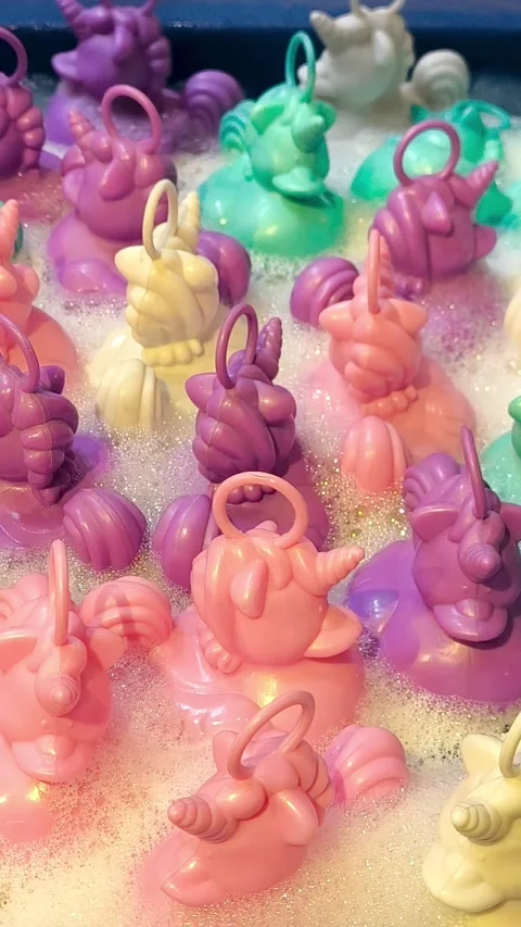 Rubber unicorns in thick soapy foam. A fun bath toy. Stock Footage 323972714