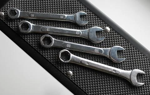 Rubberized mat to prevent slipping with set of combination spanners on it Stock Photos
