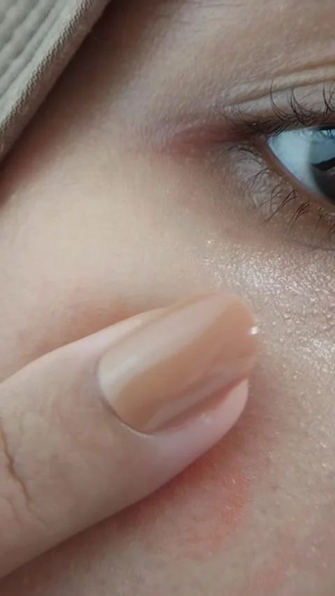 Rubbing and spreading blush evenly across the cheek area. Natural makeup ap.. Stock Footage 332227580