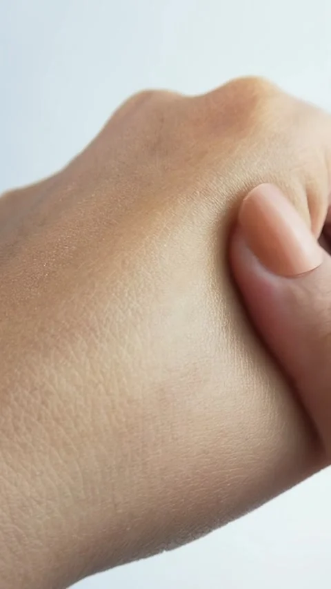 Rubbing back of hand with index finger. Close up of beauty skincare cream a.. Stock Footage 336238709