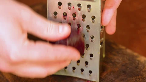 Rubbing the beetroot on metal grater Stock Footage 250440625