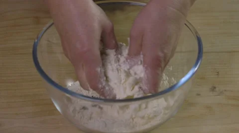 Rubbing butter into flour by hand. Stock Footage 64009645