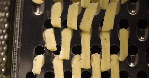 Rubbing Cheese on Grater Extremely closeup Macro shot 4K Stock Footage 104048980