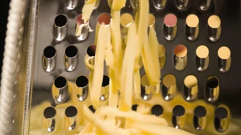 Rubbing Cheese on Grater Extremely closeup Macro shot Slow motion Stock Footage 104062487