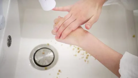 Rubbing Exfoliating Scrub on Back of Hand Stock Footage 334829575