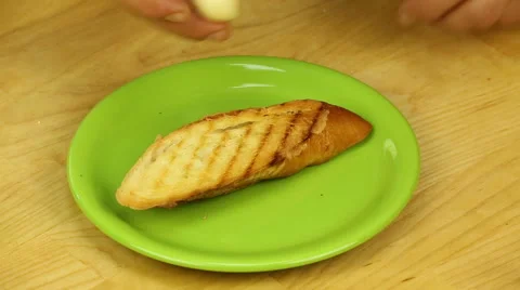 Rubbing garlic croutons Stock Footage 68784389