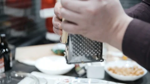 Rubbing on the grating of yellow cheese Stock Footage 107084589