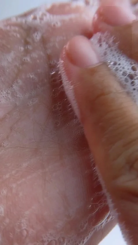 Rubbing hand soap foam up close slowly, maintaining cleanliness, skin care Stock Footage 335296950