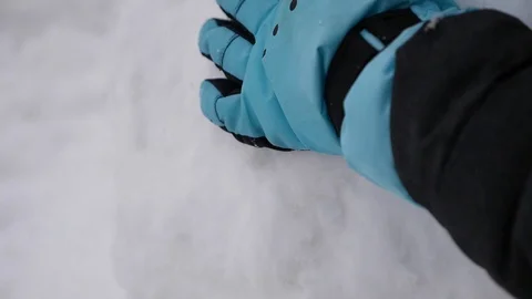 Rubbing snow with one hand in winter gloves Stock Footage 87647004