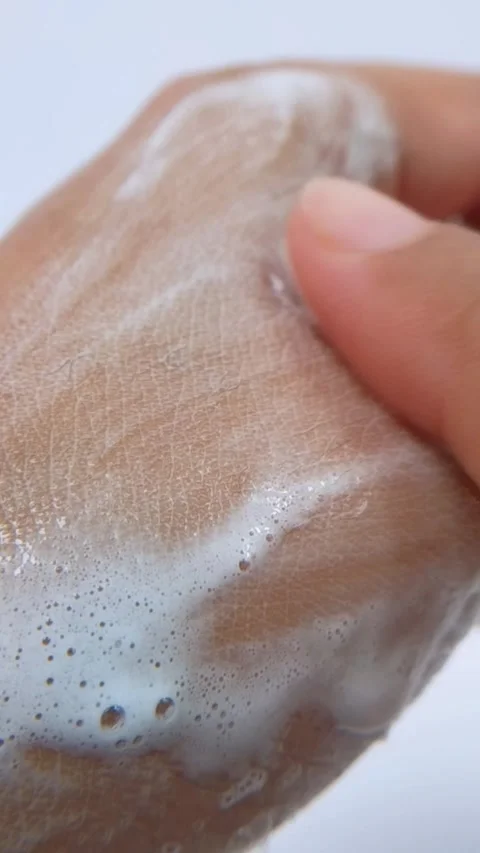 Rubbing soap slowly on the back of hand. Close up view isolated on white ba.. Stock Footage 335296987