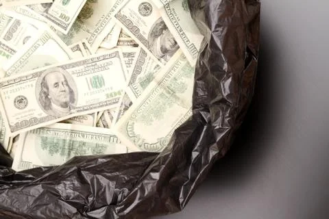 Rubbish bag with dollars Stock Photos
