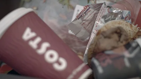 Rubbish in a bin, with tea bag, plastic and coffee cup Stock Footage 85824364