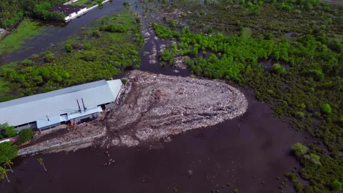 Rubbish dump polluting coastal marshland ecosystem. Magic aerial view drone Stock-Footage 344601663