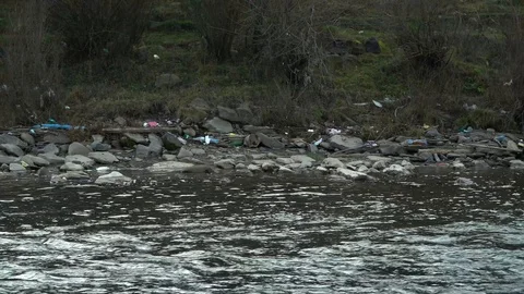 Rubbish on the river. Garbage in a mountain river. Environmental pollution Video stock 98773791