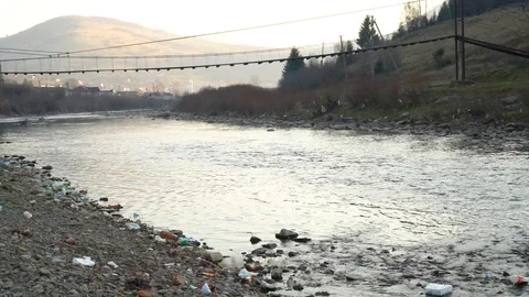 Rubbish on the river. Garbage in a mountain river. Environmental pollution Stock Footage 98840131