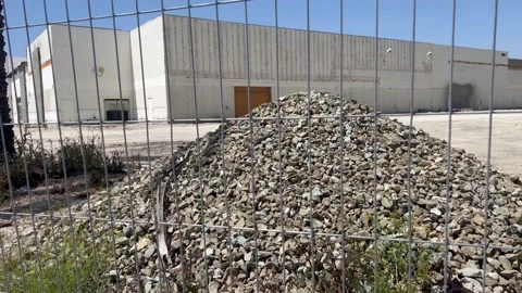 Rubble Pile Through Fence Stock Footage 239757818