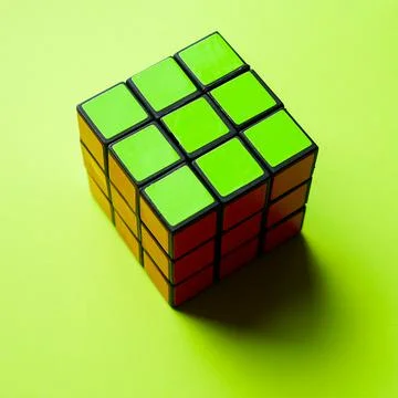 Rubik's cube green side on a table with black shadow Foto stock