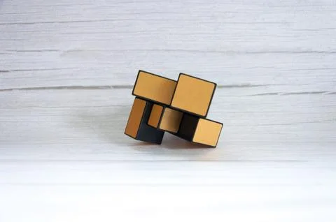 Rubik's cube on a grey wooden table. Play concept. Stock Photos