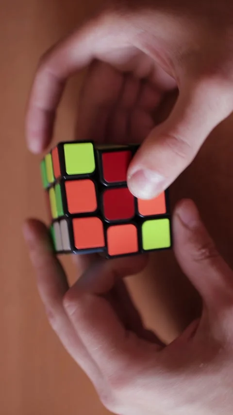 Rubik's cube in the hands of a man close up. Vertical video. Stock Footage 270356438