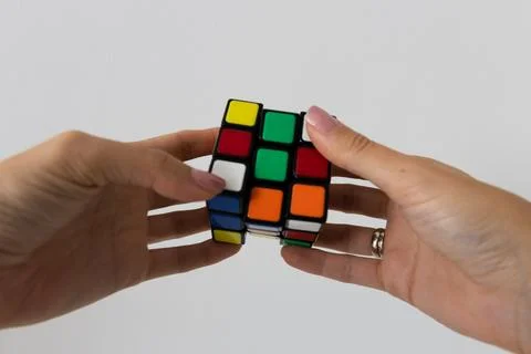Rubik's cube in hands puzzle task Stock Photos