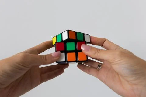 Rubik's cube in hands puzzle task Stock Photos