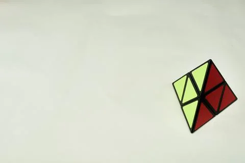 Rubik's cube pyramorphix, solved on white background with copy space 2 Stock Photos