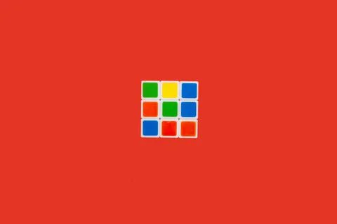 Rubiks Cube on a red background. toy Stock Photos