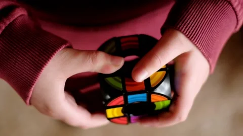 Rubik's Cube. Round  puzzles in children's hands Stock Footage 149372074