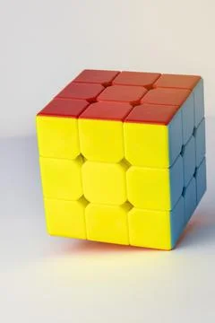 Rubik's cube on a white background. Problems on logic, Cube of yellow red and 库存照片