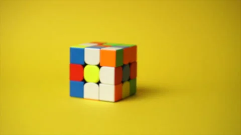 Rubiks cube at yellow background Stock Footage