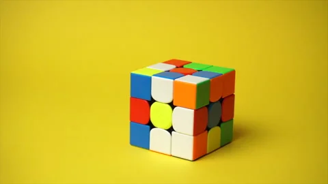 Rubiks cube at yellow background Stock Footage 184881433