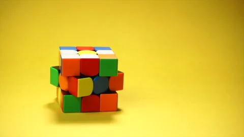 Rubiks cube at yellow background Stock Footage 185961493