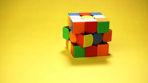 Rubiks cube at yellow background Stock Footage