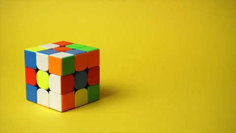 Rubiks cube at yellow background Stock Footage 185963511